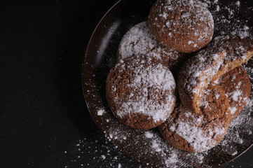 oatmeal cookies on a black table in castor sugar