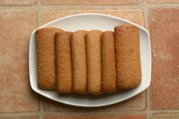 row of shortbread biscuits in white saucer