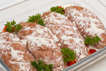 Meat minced red with aromatic seasonings on a white background.