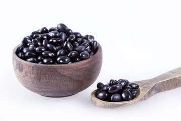Raw black beans on white background