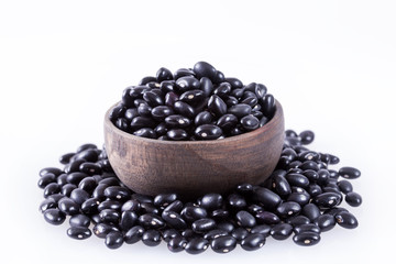 Raw black beans on white background