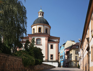 Fototapeta na wymiar Church of Holy Cross and Krizova street in Decin. Czech Republic