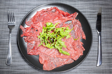 Carpaccio of Italian beef with rocket salad, parmesan and Modena balsamic vinegar cream