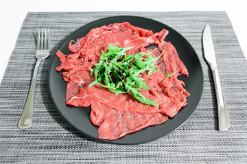 Carpaccio of Italian beef with rocket salad, parmesan and Modena balsamic vinegar cream