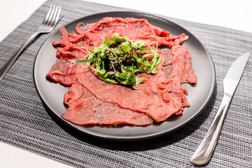 Carpaccio of Italian beef with rocket salad, parmesan and Modena balsamic vinegar cream