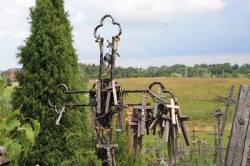 See through cross at Hill of Crosses with field behind