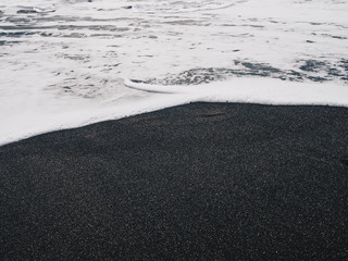 Stormy ocean waves hitting black sand beach of Ajuy in Fuerteventura, Canary Islands, Spain.