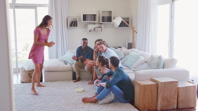 Group Of Friends At Home Having Fun Playing Charades Together