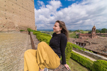 Fototapeta premium Tourist in Serralunga d'Alba castle, medieval village in Piedmont, Langhe vineyards area, north Italy