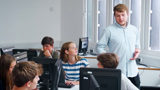 Teenage Students Studying In IT Class With Teacher