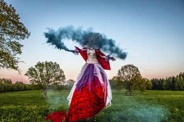 Fairy tale woman on stilts in bright fantasy stylization. Fine art outdoor photo.