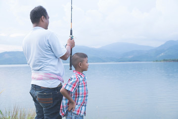 Dad teach his son fishing