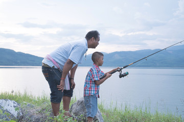 Dad teach his son fishing