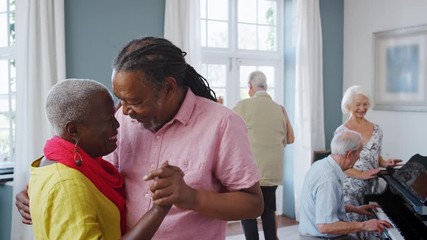 Group Of Seniors Enjoying Dancing Club Together - Powered by Adobe