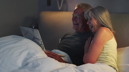 Senior Couple Using Laptop To Connect With Family For Video Call - Powered by Adobe