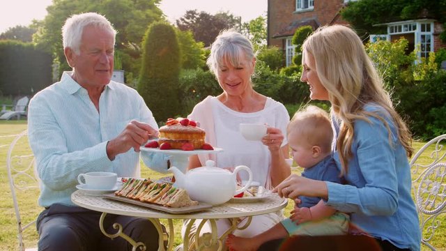 Grandparents Have Afternoon Tea With Grandson And Adult Daughter
