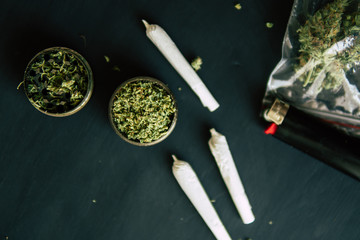 trichomes and crushed weed on a black table Joint weed Macro of cannabis buds marijuana with
