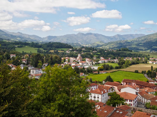 Beautiful panorama view of the town and the surrounding green countryside with the mountains in the background from the Mendiguren Citadel - Saint Jean Pied de Port, France