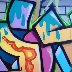 Street art. Abstract background image of a fragment of a colored graffiti painting in fashionable colors