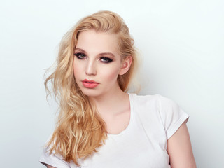 Beauty portrait of model with trendy natural make-up. Fashion shiny highlighter on skin, sexy gloss lips make-up.