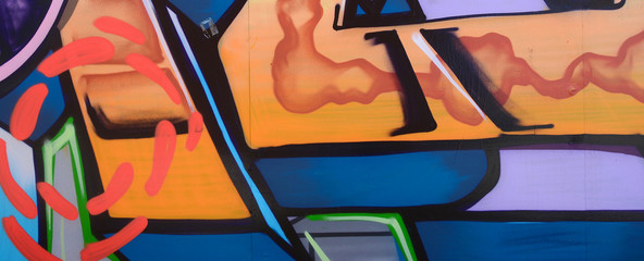 Street art. Abstract background image of a fragment of a colored graffiti painting in fashionable...
