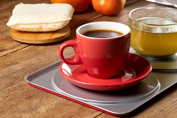 A red cup of coffee and green tae