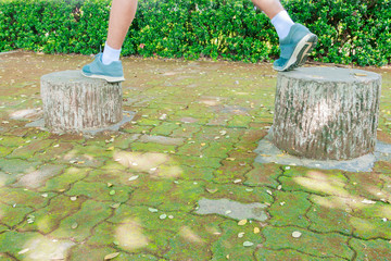 running feet male in runner jogging exercise with old shoes for health lose weight concept on concrete road public park. copy space add text