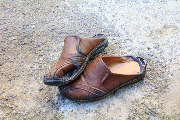 old shoes leather worn out On floor road background