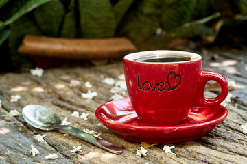 A red cup of black coffee