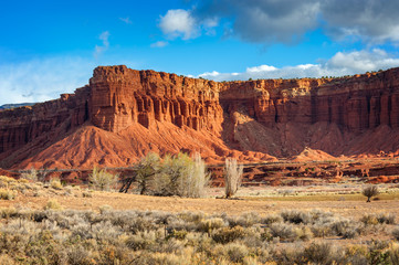 American Southwest Desert Landscape. Classic eroded Navaho sandstone bluffs and blue skies bring up an image of the old west. This is especially true here in Torrey, Utah, near Capitol Reef Park.