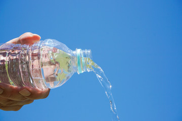 Water flows from the plastic bottle. Image of hydration.  ペットボトルから水が流れる　水分補給のイメージ
