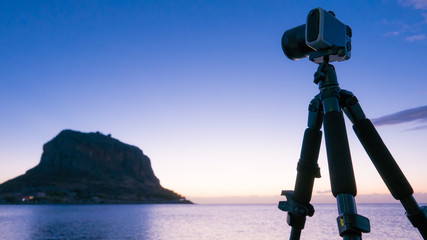 Camera and Monemvasia island at sunrise