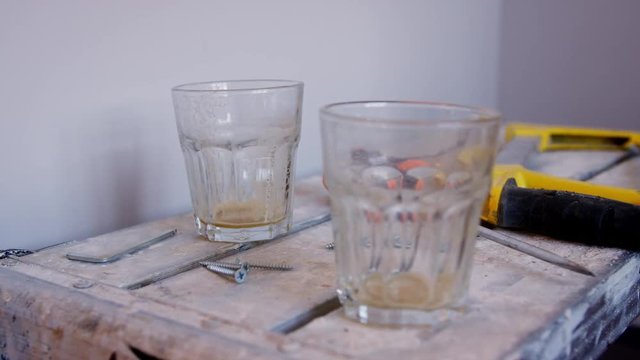 Close Up Of Empty Drinking Glasses On Workmans Trestle Table