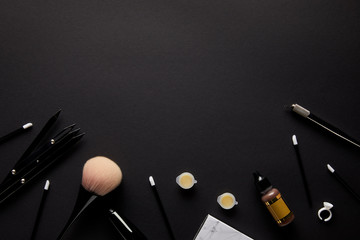elevated view of tools for permanent makeup isolated on black