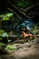 girl and dog in forest - 207219077