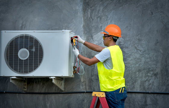 Technician is checking outdoor air conditioner unit