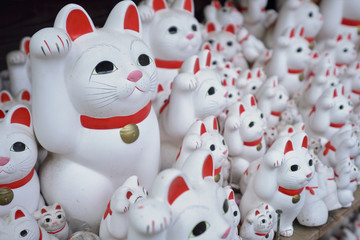 Maneki-neko lucky cats at Goutokuji Shrine, Tokyo, Japan