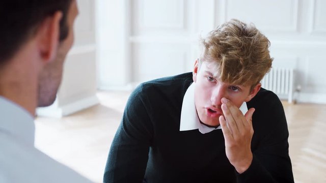 School Counselor Talking To Depressed Male Pupil