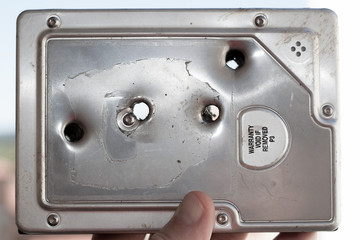 4 bullet holes in a very dead hard drive