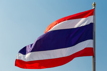 Waving flag of Thailand on blue sky