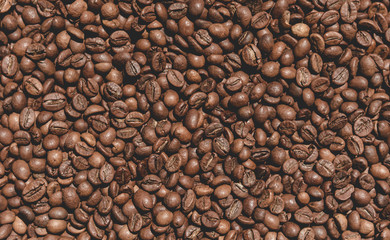 Closeup texture of coffee beans on the table. Coffee background