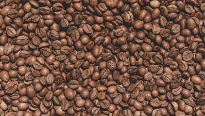 Closeup texture of coffee beans on the table. Coffee background