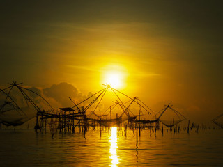 Naklejka na ściany i meble silhouetteThai traddition lift fishing equipment in morning light at Pakpra, Patthalung province, Thailand,
