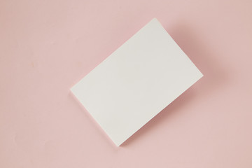 Blank business card on pink background
