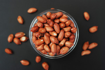 Peanuts Isoalted on Black Board. Fried Nuts, Peanuts in glass Bowl.