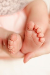 Fototapeta na wymiar mother hold feets of newborn baby