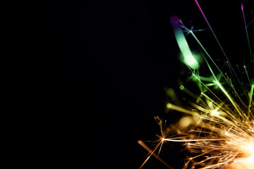 Sparkler background / A sparkler is a type of hand-held firework that burns slowly while emitting...