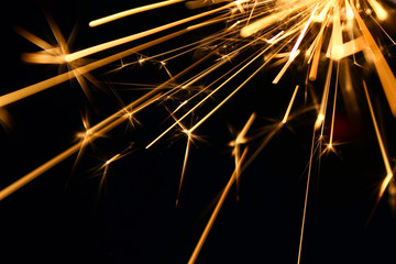 Sparkler background / A sparkler is a type of hand-held firework that burns slowly while emitting...