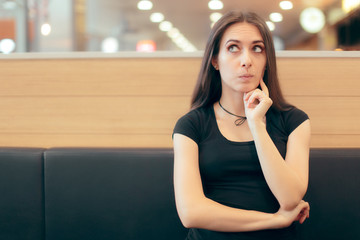 Woman Sitting in Fast Food Restaurant Thinking While Waiting