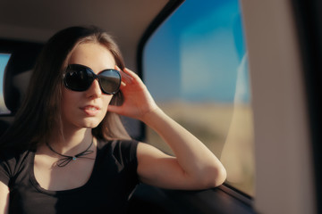 Fototapeta premium Woman with Big Sunglasses Traveling by Car